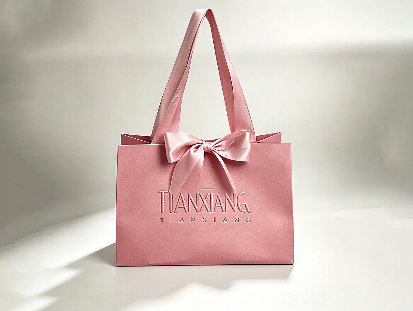High-quality Custom-designed Luxurious Embossed Craftsmanship Solid-colored Bow-shaped Gift Bag With Silk Handle