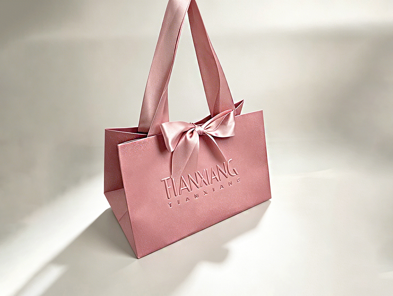 High-quality Custom-designed Luxurious Embossed Craftsmanship Solid-colored Bow-shaped Gift Bag With Silk Handle